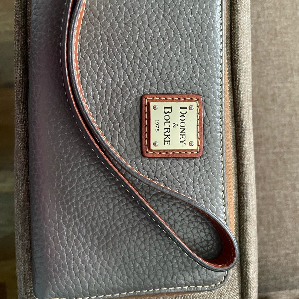A compact wristlet wallet. European grain leather
